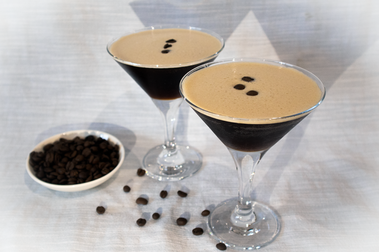 A picture of two Espresso Martinis and some coffee beans
