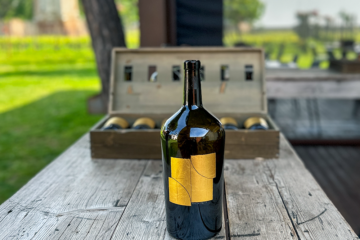 Image of Venissa wine bottle with 2015 gold leaf label and a box of wines behind.