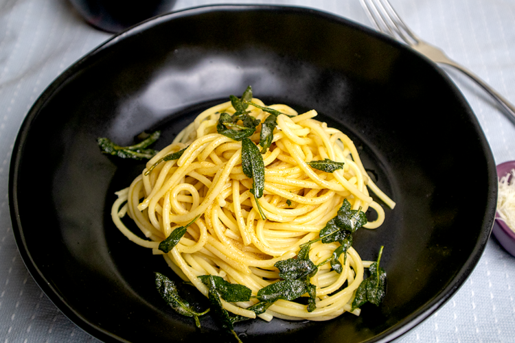 Picture of a bowl of spaghetti with butter and sage sauce.
